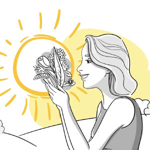 Frau hält Blumen vors Gesicht, im Hintergrund ist eine gelbe Sonne